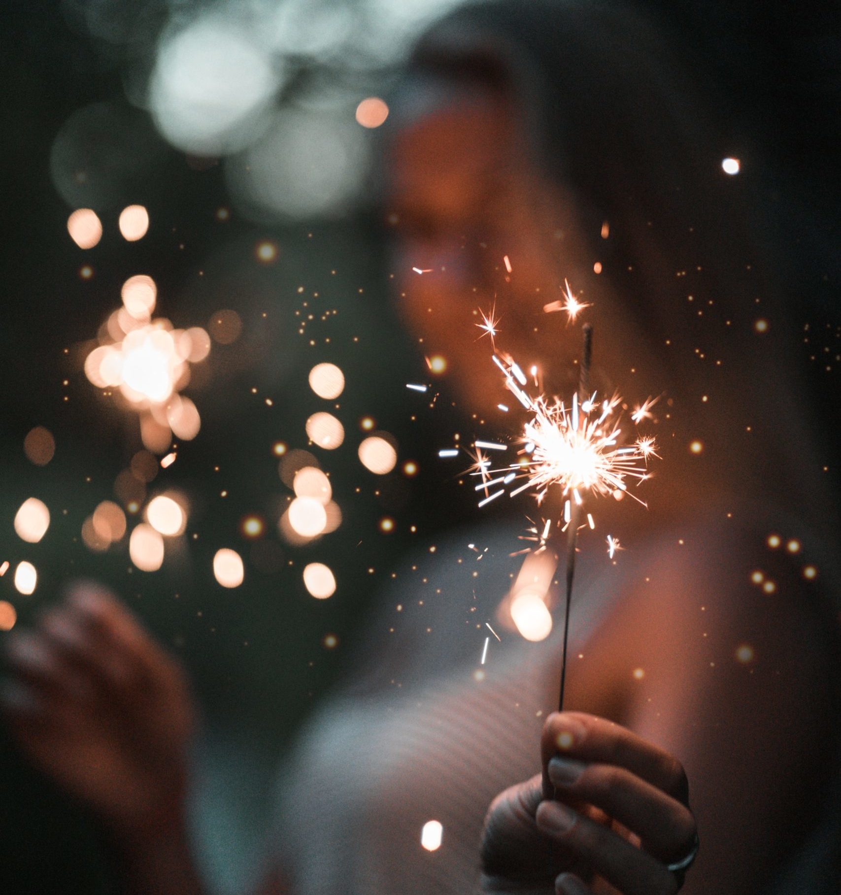woman holding fire cracker in selective focus photography